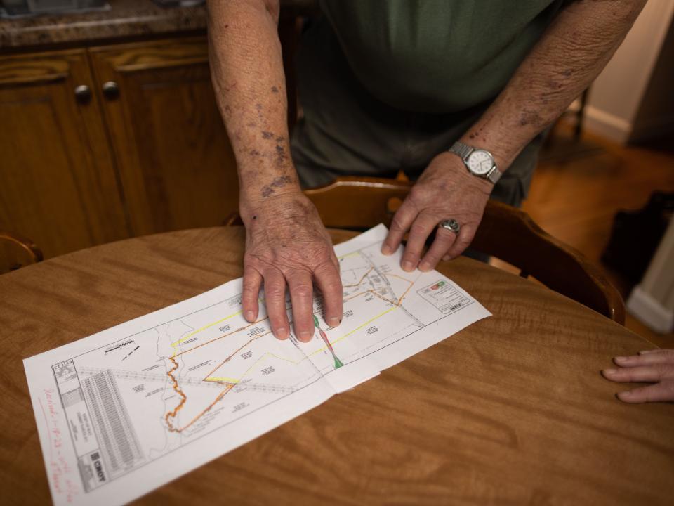 Don Garrett pointing at a map showing the Sandersville Railroad's plan for the Hanson Spur.