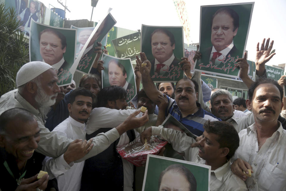 Supporters of Pakistani Prime Minister Nawaz Sharif celebrate the suspension of prison sentences of Sharif, his daughter and son-in-law, in Lahore, Pakistan, Wednesday, Sept. 19, 2018. The Islamabad High Court set them free on bail pending their appeal hearings. The court made the decision on the corruption case handed down to the Sharifs by an anti-graft tribunal earlier this year. (AP Photo/K.M. Chaudary)