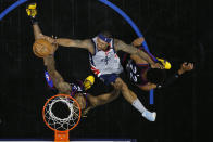 Washington Wizards' Bradley Beal, center, goes up for a shot against Philadelphia 76ers' Dwight Howard, left, and Matisse Thybulle during the second half of Game 2 in a first-round NBA basketball playoff series, Wednesday, May 26, 2021, in Philadelphia. (AP Photo/Matt Slocum)