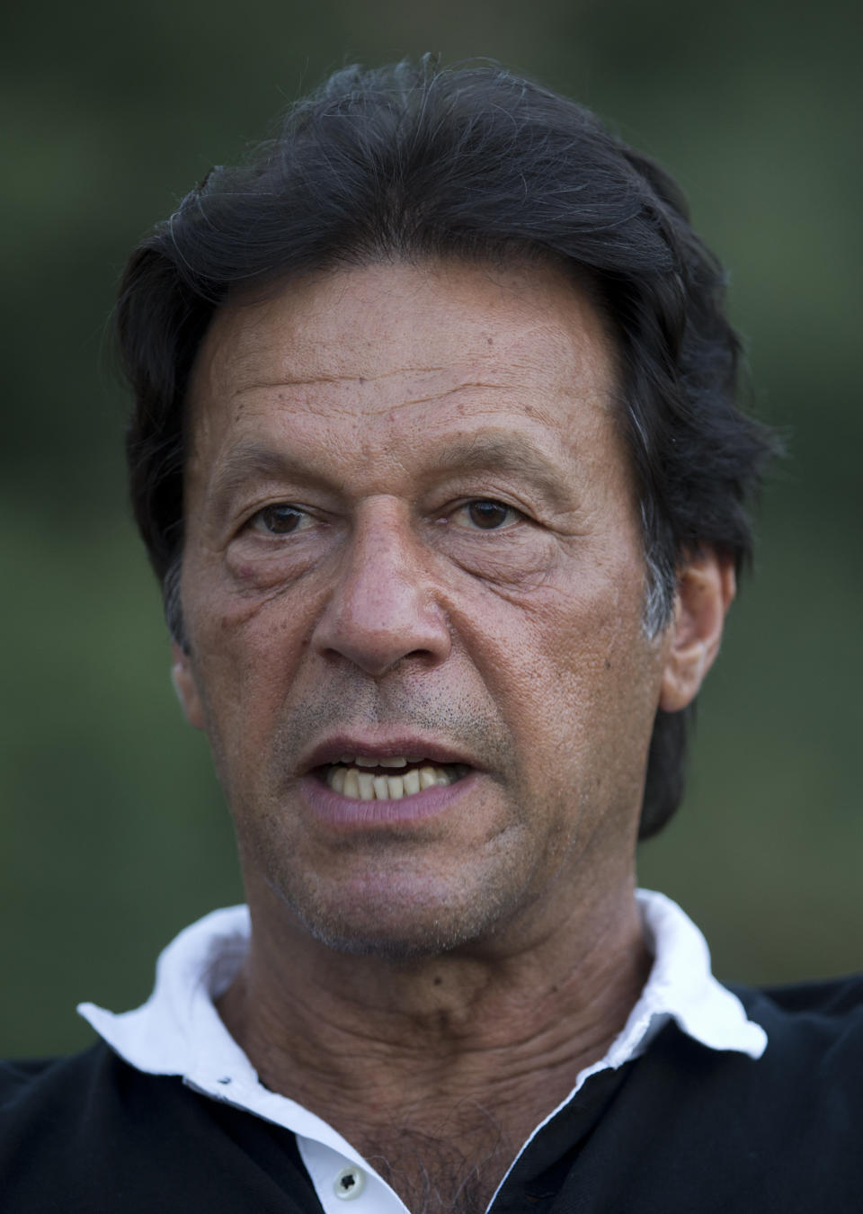 In this photo taken on Sept. 25, 2017 in Islamabad, Pakistan, Pakistan's cricketer-turned politician Imran Khan heads the center-right Pakistan Tehrik-e-Insaf party. Khan, who is tipped to win the polls, faces his stiffest competition from ex-premier Nawaz Sharif's Pakistan Muslim League party. Pakistan's parliamentary elections on July 25 will mark the second time a democratically elected government in this Islamic nation has been succeeded by another. (AP Photo/B.K. Bangash)