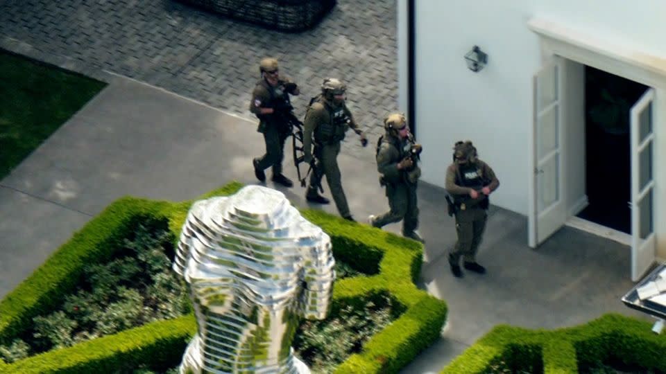 Members of law enforcement are seen outside of Sean "Diddy" Combs' home in Los Angeles on March 25, 2024. - KCAL/KCBS