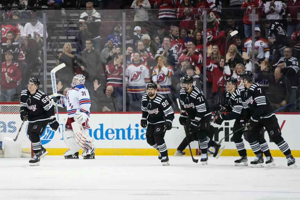 New Jersey Devils' Erik Haula (56) leads teammates past New York Rangers goaltender Igor Shesterkin (31) after scoring a goal during the first period of an NHL hockey game Thursday, March 30, 2023, in Newark, N.J. (AP Photo/Frank Franklin II)