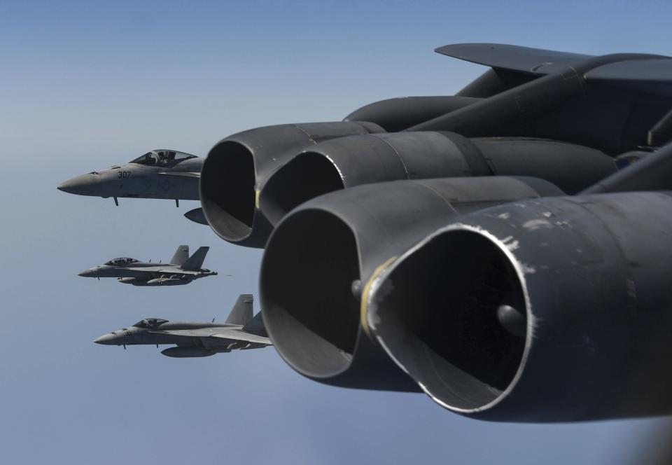 In this Saturday, June 1, 2019 photo, U.S. Navy F-18 Hornets form up off the wing of a U.S. Air Force B-52H Stratofortress assigned to the 20th Expeditionary Bomb Squadron, and part of the Bomber Task Force deployed to the region conduct joint exercises in the U.S. Central Command area of responsibility in Arabian sea. (Staff Sgt. Erin Piazza/U.S. Air Force via AP)