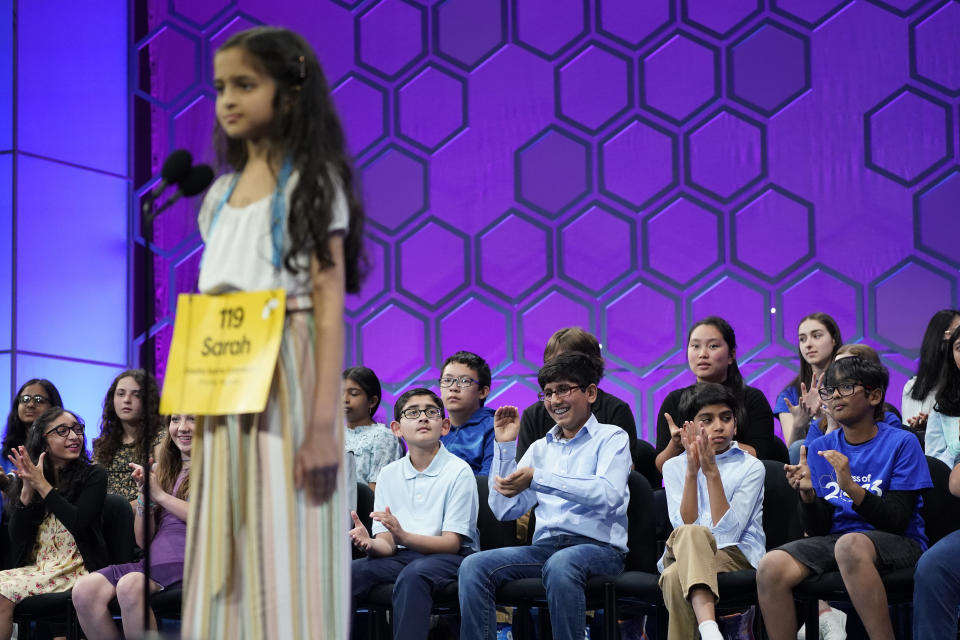 Other contestants watch as Sarah Fernandes, 11, from Omaha, Neb., competes during the finals of the Scripps National Spelling Bee, Thursday, June 1, 2023, in Oxon Hill, Md. (AP Photo/Nathan Howard)