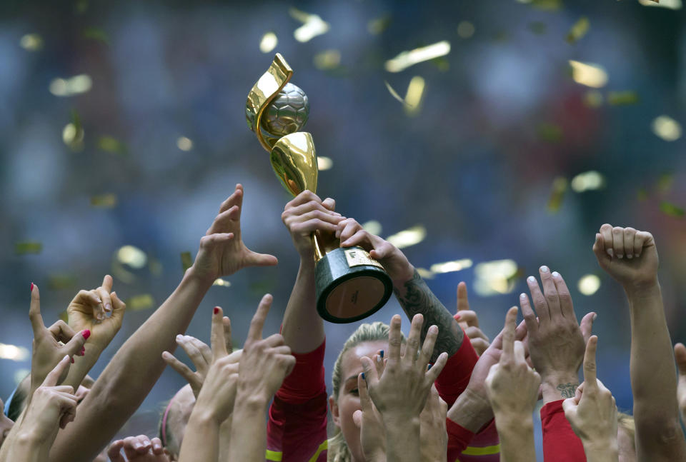 FILE - In this July 5, 2015, file photo, the United States Women’s National Team celebrates with the trophy after they defeated Japan 5-2 in the FIFA Women’s World Cup soccer championship in Vancouver, British Columbia, Canada. People with knowledge of FIFA’s finances told The Associated Press that in the four-year period covering the 2018 World Cup, FIFA’s reserves soared to $2.74 billion and revenue rose to $6.4 billion, but it also underscores the glaring disparity between men and women’s soccer. (Darryl Dyck/The Canadian Press via AP, File)