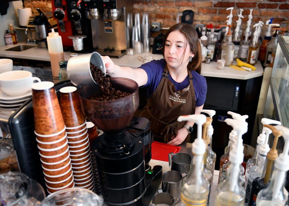 Barista Danielle McManus prepares to grind coffee beans at Casciano Coffee Bar & Sweetery in Hammonton, N.J.