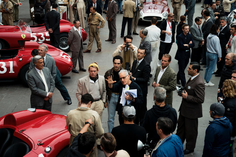 Director Michael Mann (center, in sunglasses), directs Jack O'Connell (in yellow hat) and Gabriel Leone (to O'Connell's left), who play racecar drivers Peter Collins and Alfonso De Portago, on the set of "Ferrari." (Eros Hoagland)