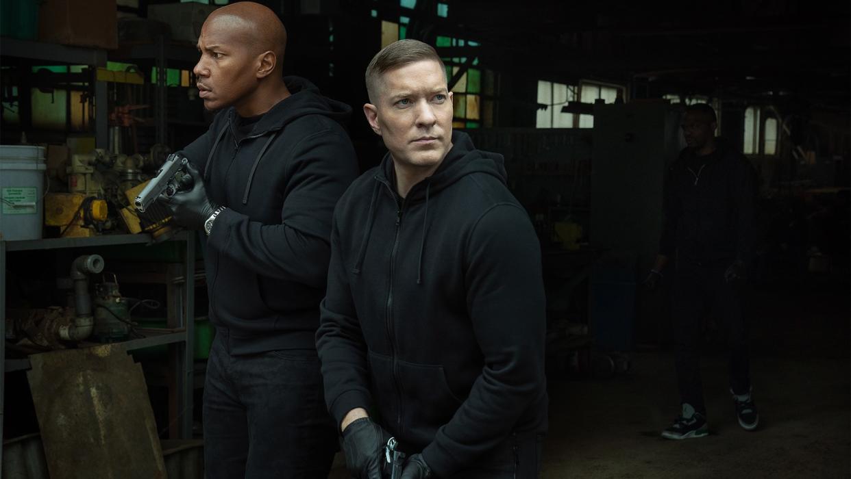  Isaac Keys and Joseph Sikora as Diamond and Tommy in all black holding guns in Power Book IV: Force. 