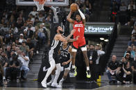 Houston Rockets' Jalen Green (4) looks to pass as San Antonio Spurs' Julian Champagnie and Devin Vassell (24) defend during the first half of an NBA basketball game Tuesday, March 12, 2024, in San Antonio. (AP Photo/Darren Abate)