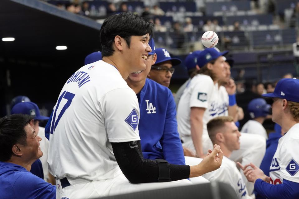 Los Angeles Dodgers' designated hitter Shohei Ohtani smiles during the first inning of the exhibition game between the Los Angeles Dodgers and Kiwoom Heroes at the Gocheok Sky Dome in Seoul, South Korea, Sunday, March 17, 2024. The Los Angeles Dodgers and the San Diego Padres will meet in a two-game series on March 20th-21st in Seoul for the MLB World Tour Seoul Series. (AP Photo/Ahn Young-Joon)
