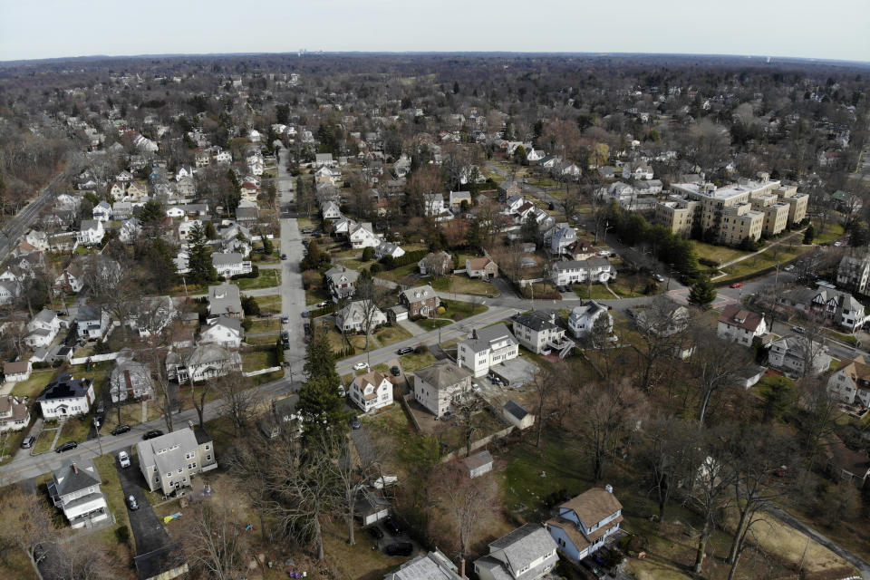 A suburban area that mostly falls within the containment area is seen from the south end of the containment area in New Rochelle, N.Y., Wednesday, March 11, 2020. State officials are shuttering several schools and houses of worship for two weeks in the New York City suburb and sending in the National Guard to help with what appears to be the nation's biggest cluster of coronavirus cases, Gov. Andrew Cuomo said Tuesday. (AP Photo/Seth Wenig)