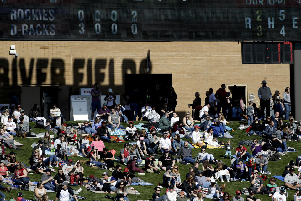 A pitch clock, right, counts down during the fifth inning of a spring baseball game between the Arizona Diamondbacks and the Colorado Rockies in Scottsdale, Ariz., Saturday, Feb. 23, 2019. Baseball debuts an experimental pitch clock through spring training on Saturday, putting hurlers and hitters on the clock for the first time in an effort to shorten games. (AP Photo/Chris Carlson)