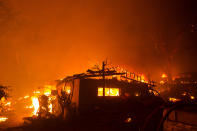 A home is consumed by flames in the Lake Hughes fire in Angeles National Forest on Wednesday, Aug. 12, 2020, north of Santa Clarita, Calif. (AP Photo/Ringo H.W. Chiu)