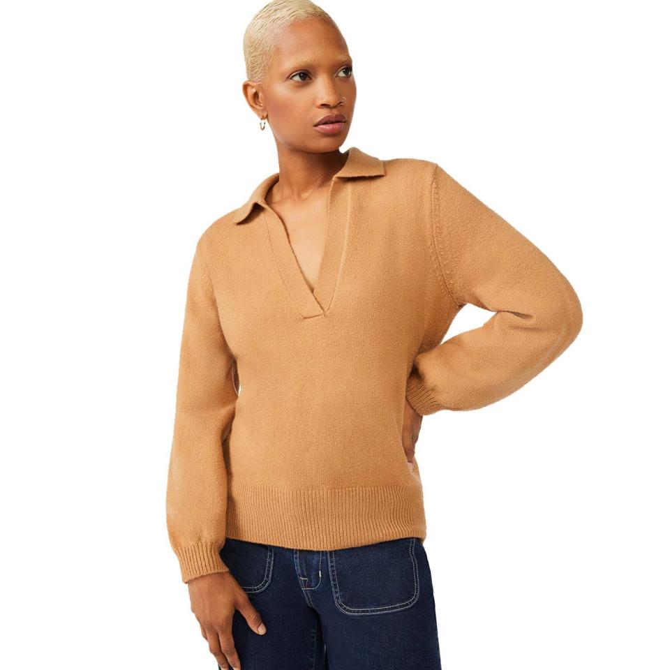 woman wearing brown polo sweater and dark blue jeans