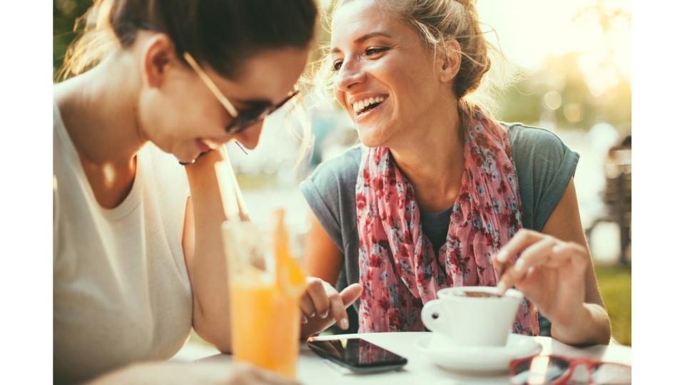 Female friends talking in cafe