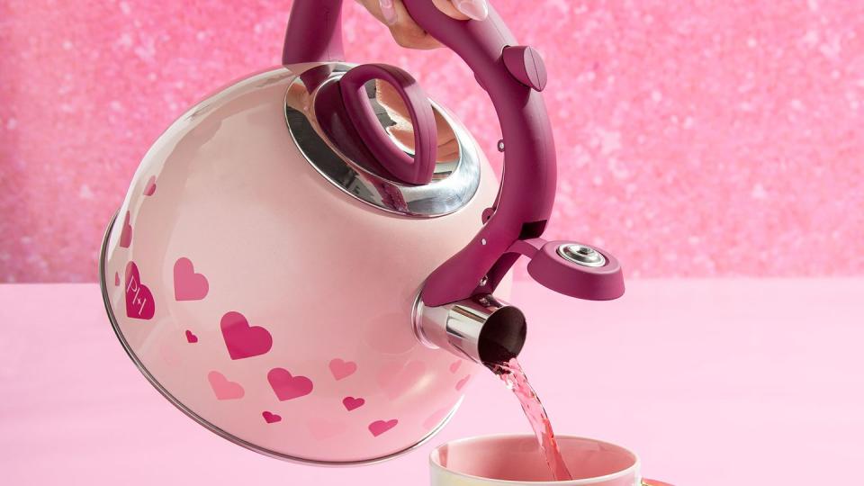 a pink teapot pouring into a mug