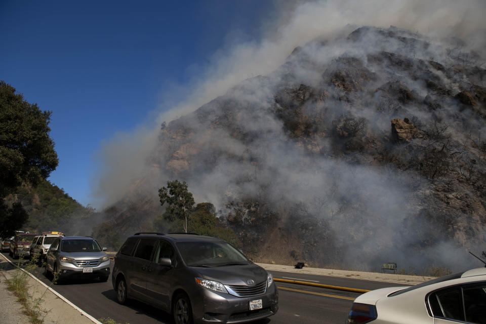 Palisades residents flee the area as a wildfire erupts in the Pacific Palisades area of Los Angeles, Monday, Oct. 21, 2019. (AP Photo/Christian Monterrosa)