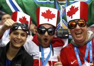 Team Canada fans await the start of the men's preliminary round ice hockey game against Norway at the Sochi 2014 Sochi Winter Olympics, February 13, 2014. REUTERS/Jim Young (RUSSIA - Tags: OLYMPICS SPORT ICE HOCKEY)