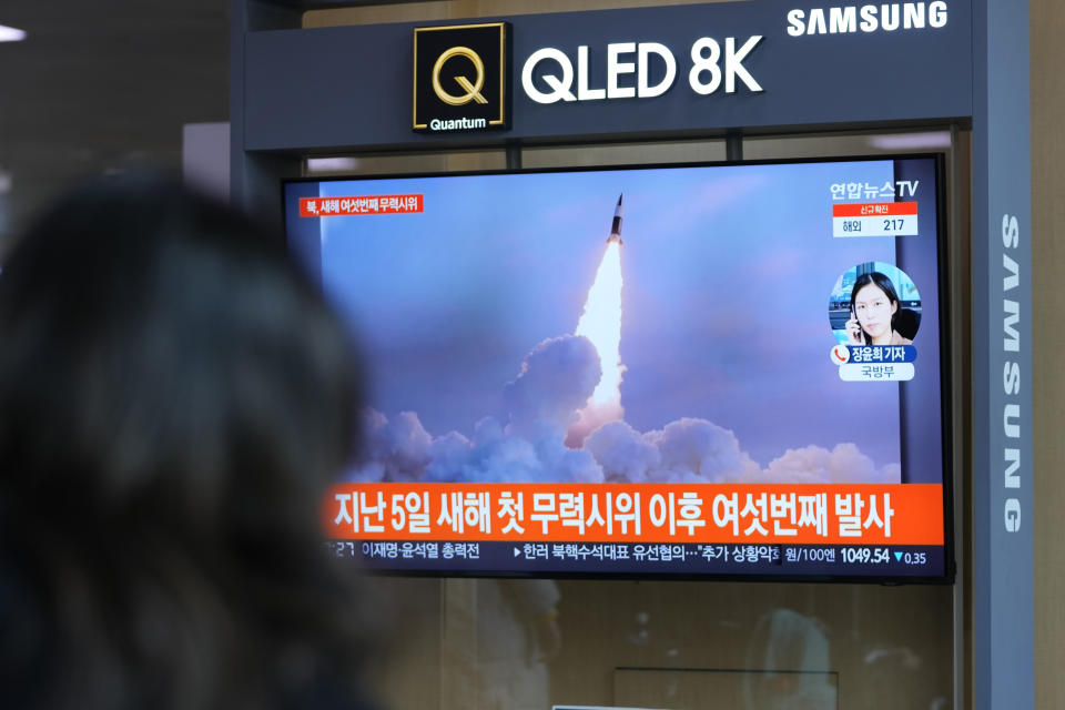 A woman watches a TV screen showing a news program reporting about North Korea's missile launch with a file image, at a train station in Seoul, South Korea, Thursday, Jan. 27, 2022. North Korea on Thursday fired at least two suspected ballistic missiles into the sea in its sixth round of weapons launches this month, South Korea's military said. A part of letters read "6th launch in 2022." (AP Photo/Lee Jin-man)