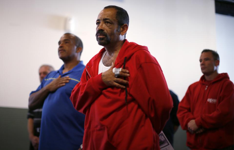 Veterans listen during a Veterans Day observance for homeless veterans at The Midnight Mission shelter on skid row in Los Angeles