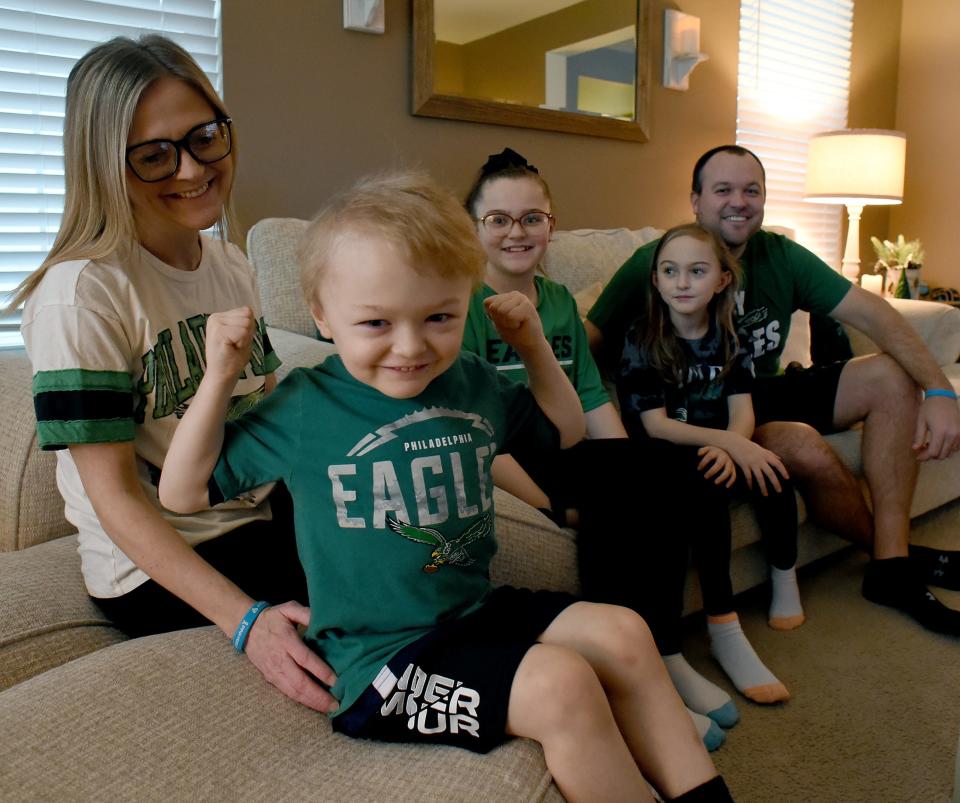 Charley Myers, 4, of Monroe shows his muscles like the Philadelphia Eagles football team with his family: mom, Alissa; sisters, Molly, 11, and Lilly, 8; and his dad, Chad, as they are now fans of the Philadelphia Eagles after a recorded encouragement video by Eagles defensive end Brandon Graham was sent to Charley, who is battling leukemia.
