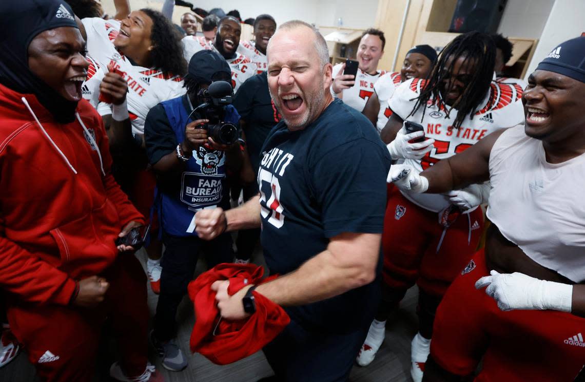 N.C. State head coach Dave Doeren celebrates in the locker room after N.C. State’s 30-27 overtime victory over UNC at Kenan Stadium in Chapel Hill, N.C., Friday, Nov. 25, 2022. Ethan Hyman/ehyman@newsobserver.com