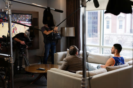 Turkish NBA player Enes Kanter watches his team, the New York Knicks, play the Washington Wizards at the O2 Arena in London on television while being filmed and interviewed by ESPN in White Plains, New York, U.S., January 17, 2019. REUTERS/Caitlin Ochs