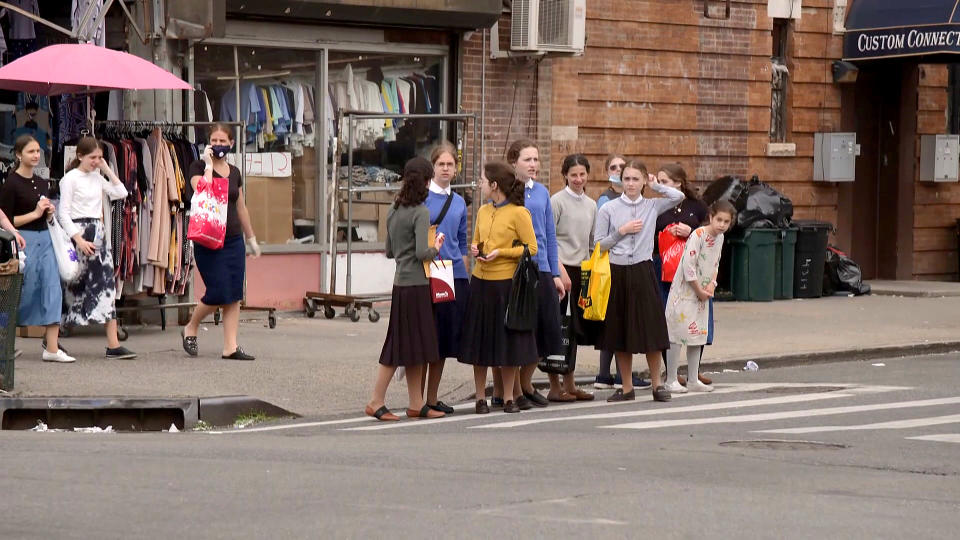 A crowd of girls gather at a crosswalk in the Borough Park neighborhood of Brooklyn, N.Y., which was hit by the virus early on. (NBC News)