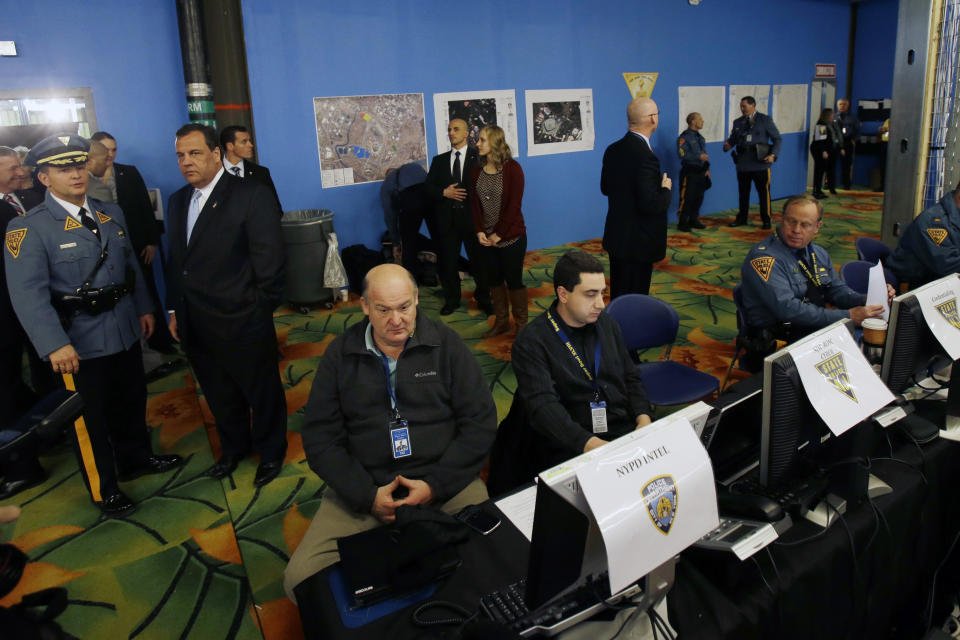 New Jersey Gov. Chris Christie, second left, visits the Super Bowl security operations center Wednesday, Jan. 29, 2014, in East Rutherford, N.J. (AP Photo/Mel Evans,pool)