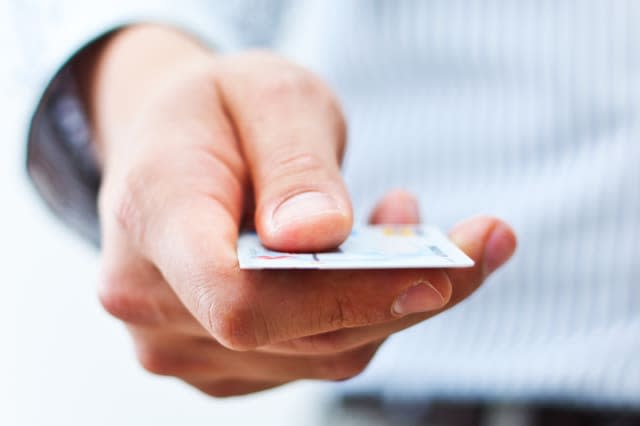 male hand showing credit card