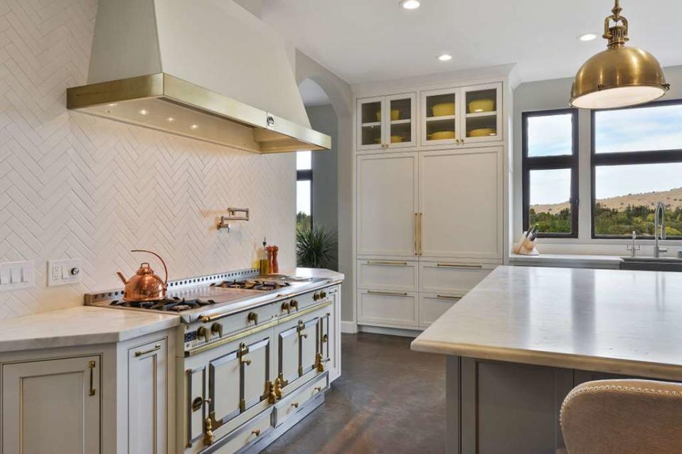 The Currys added a Carrera marble island, a La Cornue range, and two Sub-Zero refrigerators in the kitchen.