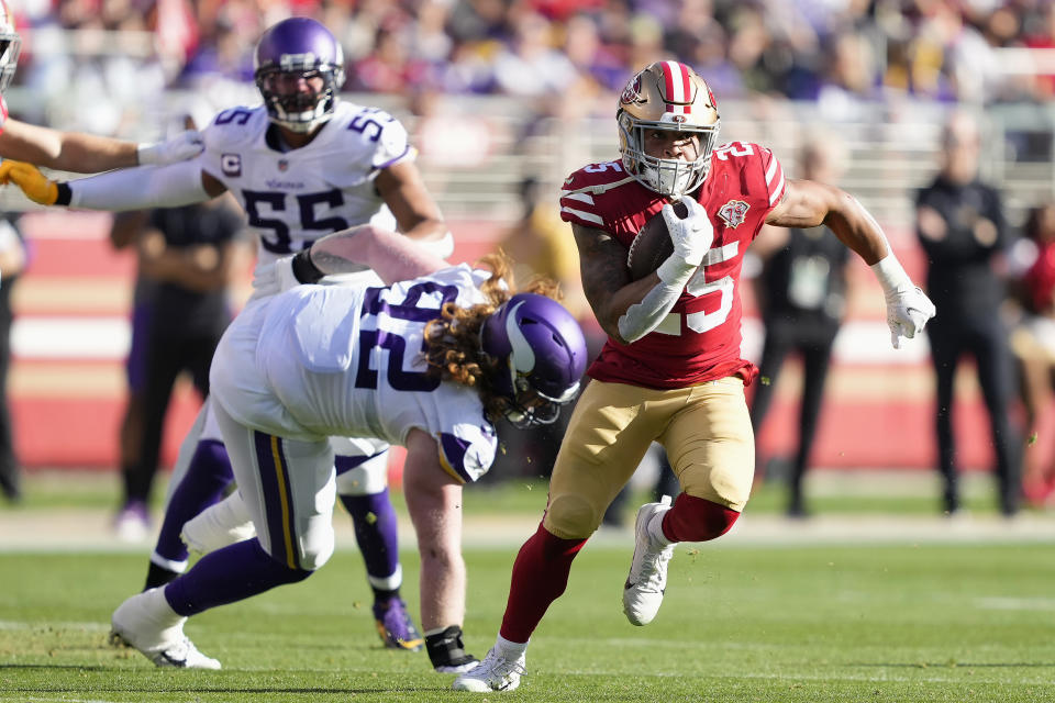 San Francisco 49ers running back Elijah Mitchell (25) runs against Minnesota Vikings defensive tackle James Lynch (92) during the first half of an NFL football game in Santa Clara, Calif., Sunday, Nov. 28, 2021. (AP Photo/Tony Avelar)