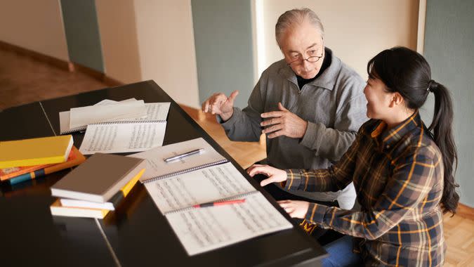 Shot of a piano teacher instructing a music studenthttp://195.