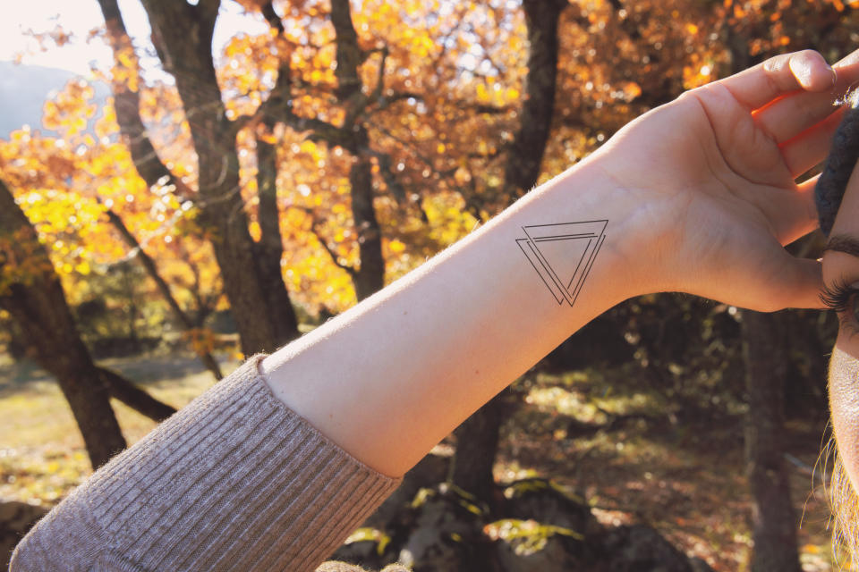 small geometric tattoo on a woman's wrist