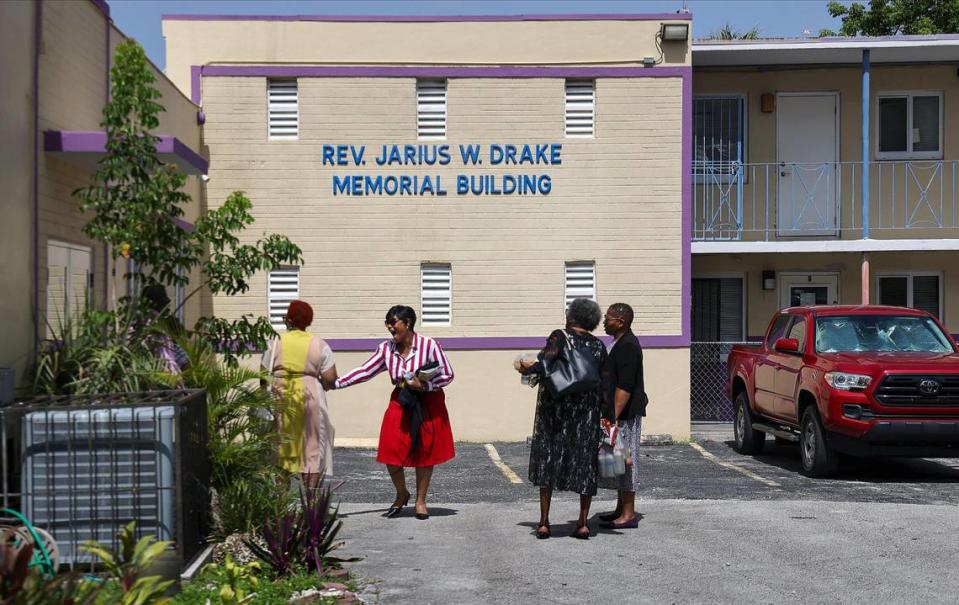 Parishioners chat outside the buildings that are facing foreclosure after Sunday service on July 23, 2023, in Miami’s historic Overtown neighborhood. St. John Institutional Missionary Baptist Church has until Aug. 14 to repay the $1.6 million mortgage taken out by the church’s former pastor, Bishop James D. Adams.