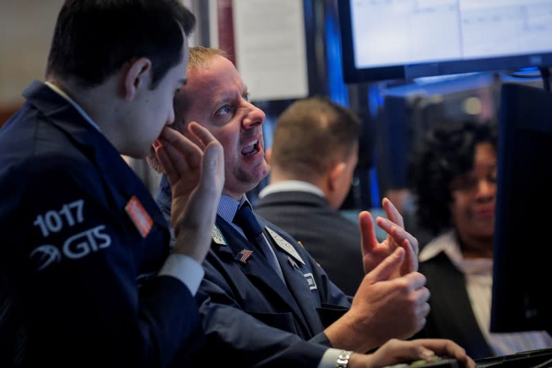 Traders work on the floor at the NYSE in New York