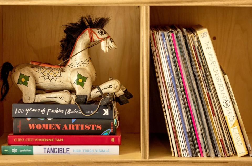 Records and books on a bookshelf.