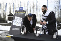 Tesla and SpaceX's CEO Elon Musk lights a candle as he visits the site of the Auschwitz-Birkenau Nazi German death camp in Oswiecim, Poland, on Monday, Jan. 22, 2024. Elon Musk visited the site of the Auschwitz-Birkenau World War II Nazi German death camp on Monday, after the billionaire faced criticism for subscribing to an antisemitic conspiracy theory and allowing hate messages on his social media platform, X, formerly known as Twitter. (EJA/Yoav Dudkevitch via AP)