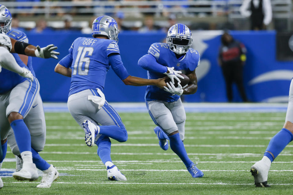 Detroit Lions quarterback Jared Goff (16) hands off to Detroit Lions running back D'Andre Swift (32) against the Philadelphia Eagles in the first half of an NFL football game in Detroit, Sunday, Sept. 11, 2022. (AP Photo/Duane Burleson)