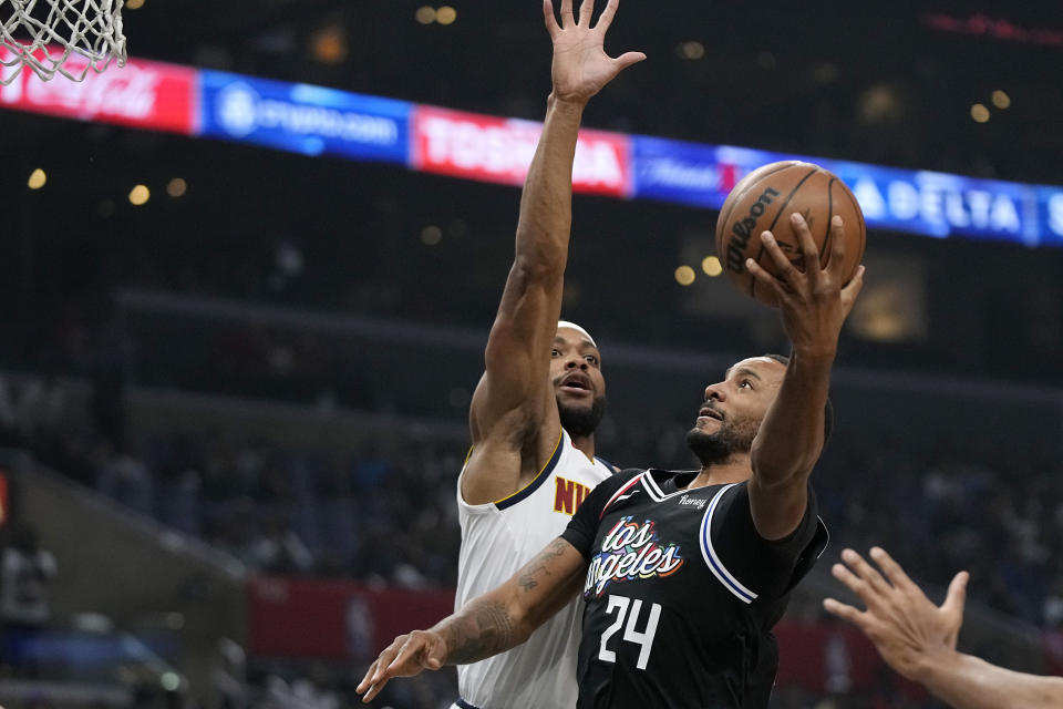 Los Angeles Clippers forward Norman Powell, right, shoots as Denver Nuggets forward Bruce Brown defends during the first half of an NBA basketball game Friday, Nov. 25, 2022, in Los Angeles. (AP Photo/Mark J. Terrill)