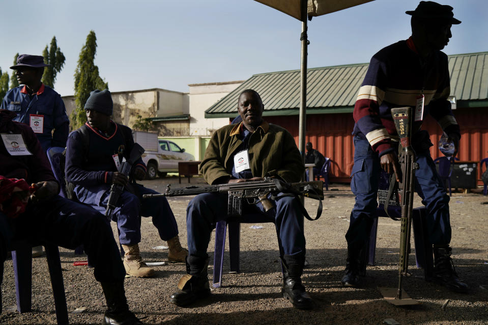 Nigerian police officers guard the Independent National Electoral Commission office in Kaduna, Nigeria, Saturday, Feb. 16, 2019. Nigeria's electoral commission delayed the presidential election until Feb. 23, making the announcement a mere five hours before polls were set to open Saturday. (AP Photo/Jerome Delay)