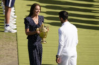 Britain's Kate, Duchess of Cambridge presents the trophy to Serbia's Novak Djokovic after he beat Australia's Nick Kyrgios in the final of the men's singles on day fourteen of the Wimbledon tennis championships in London, Sunday, July 10, 2022. (AP Photo/Gerald Herbert)
