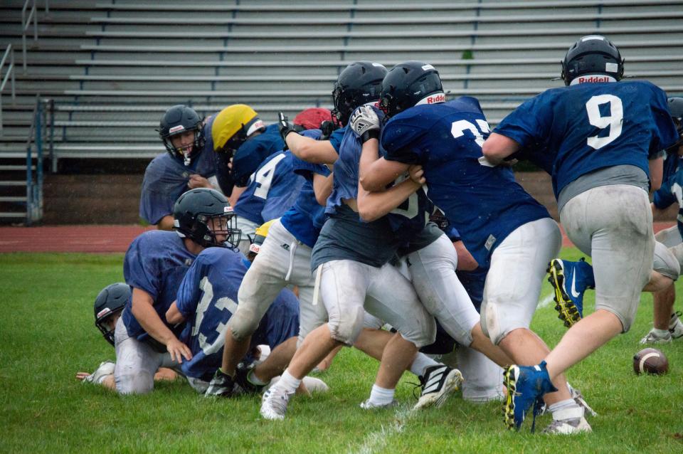 Hornet offensive and defensive lines battle in the trenches during their Blue-Gold scrimmage.