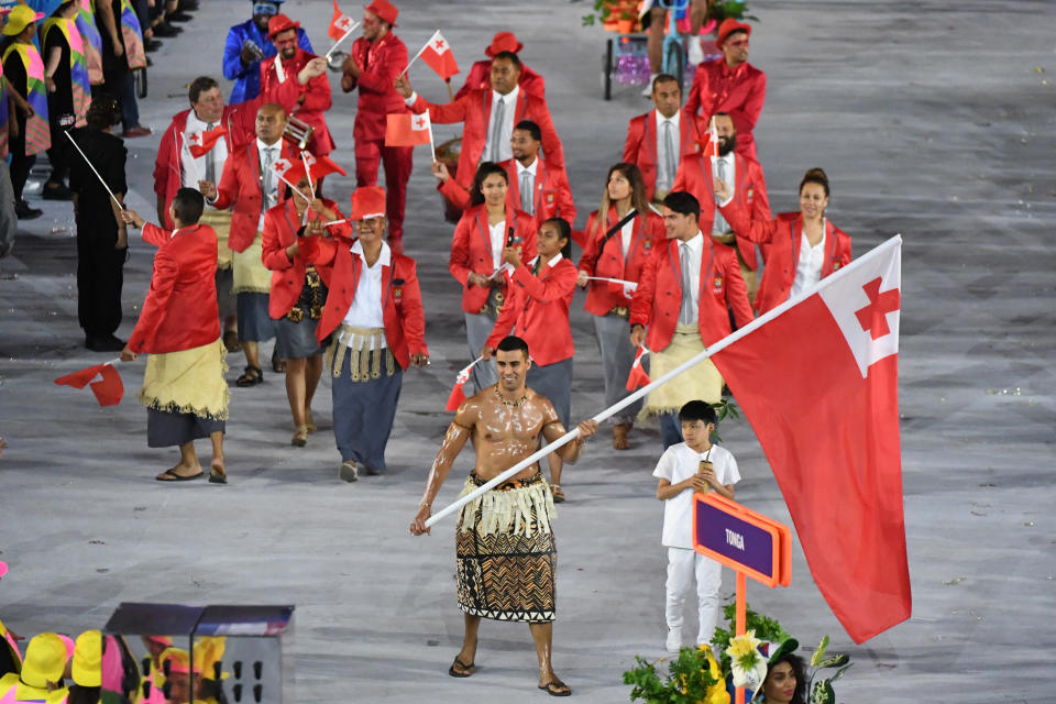 Tonga's flagbearer Pita Nikolas Taufatofua leads his delegation during the opening ceremony of the Rio 2016 Olympic Games at the Maracana stadium in Rio de Janeiro on August 5, 2016. / AFP / PEDRO UGARTE        (Photo credit should read PEDRO UGARTE/AFP via Getty Images)