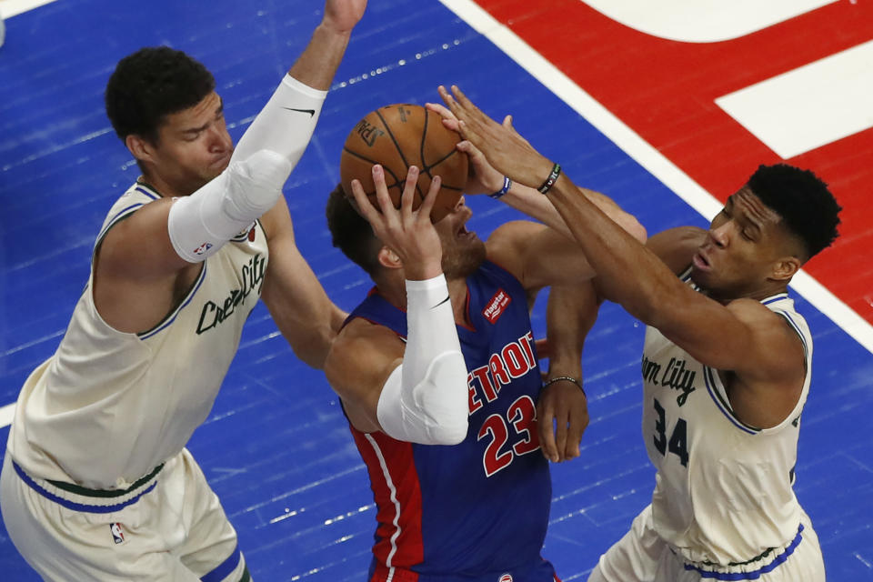 Milwaukee Bucks center Brook Lopez, left, an dMilwaukee Bucks forward Giannis Antetokounmpo (34) close in on Detroit Pistons forward Blake Griffin (23) during the first half of an NBA basketball game, Wednesday, Dec. 4, 2019, in Detroit. (AP Photo/Carlos Osorio)