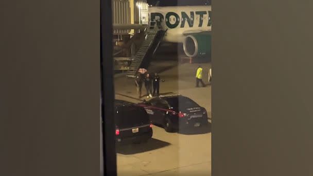 PHOTO: Bystander footage captures police escorting a passenger off a Frontier Airlines flight after it made an emergency landing at Hartsfield-Jackson Atlanta International Airport, Nov. 11, 2022. (Obtained by ABC News)