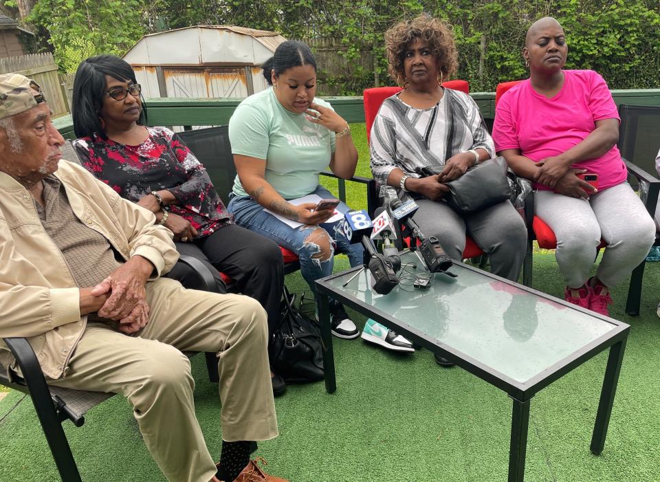 Jennifer Lopez, center, reads a message from her phone while surrounded by family members at her house in northwest Rochester May 27, 2022. Her daughter and other School 17 students were referred to in offensive terms by teachers in a group text message chain.