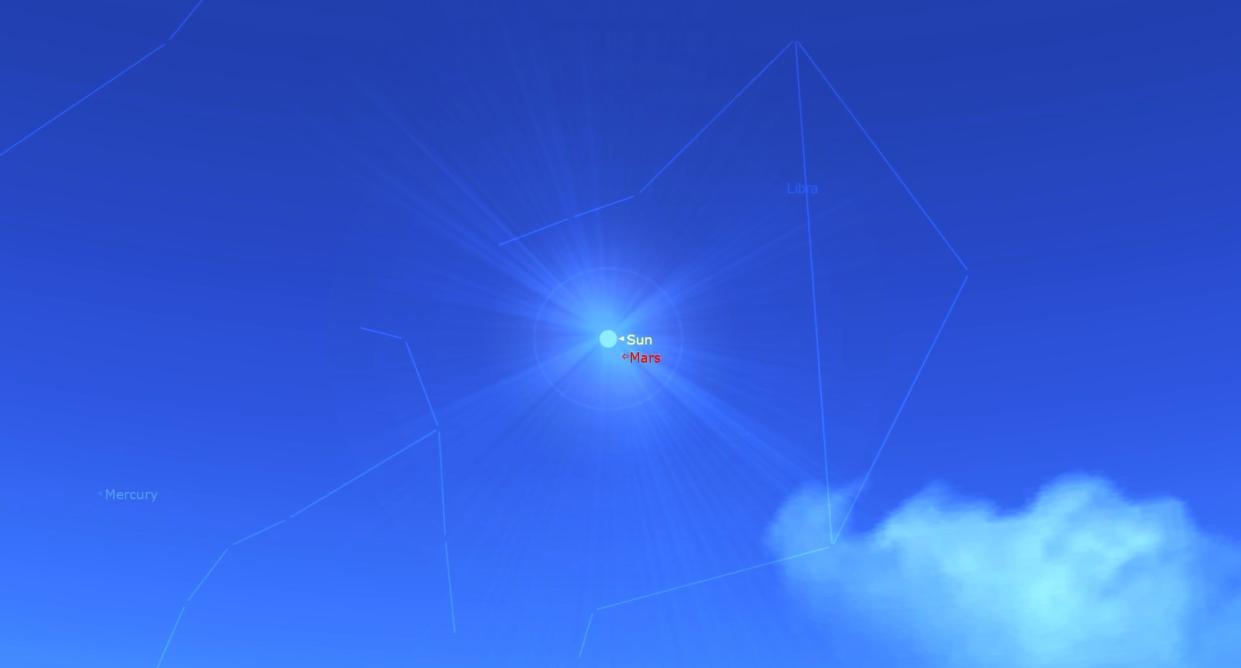  A blue sky shows a small mars near the sun. 