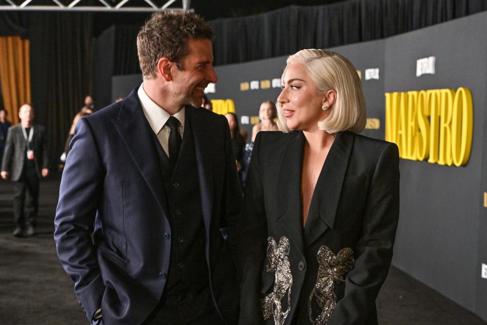 Bradley Cooper in a blue suit and Lady Gaga in a black blazer at Netflix's "Maestro" LA special screening