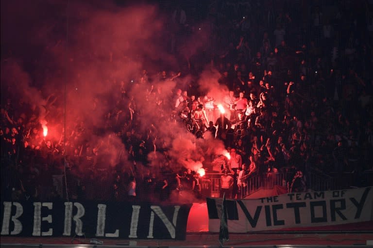 Besiktas supporters burn flares during the UEFA Europa League first leg quarter final football match against Lyon April 13, 2017, at the Parc Olympique Lyonnais stadium in Decines-Charpieu